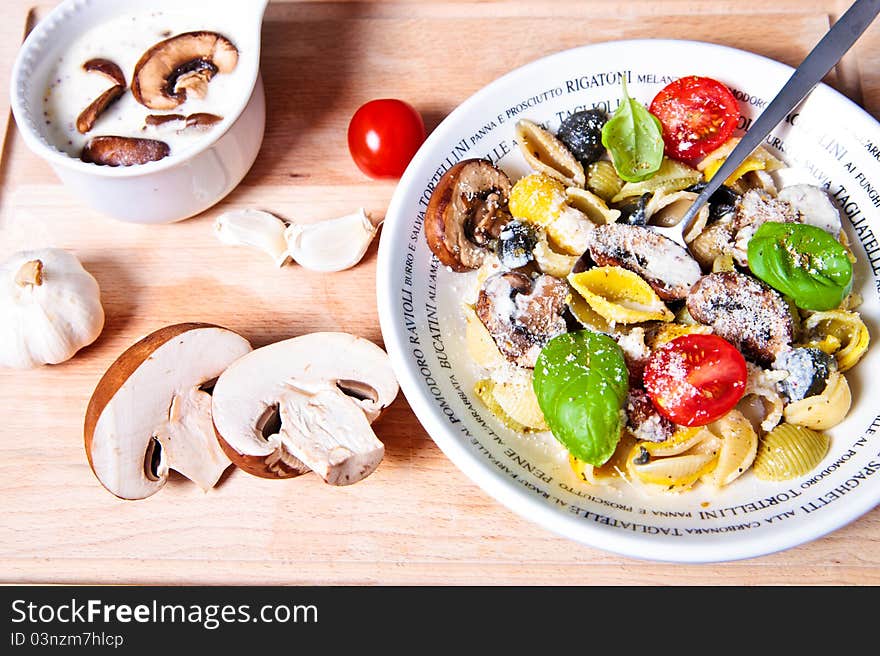 Pasta shells with mushrooms sauce, basil and tomatoes. Pasta shells with mushrooms sauce, basil and tomatoes