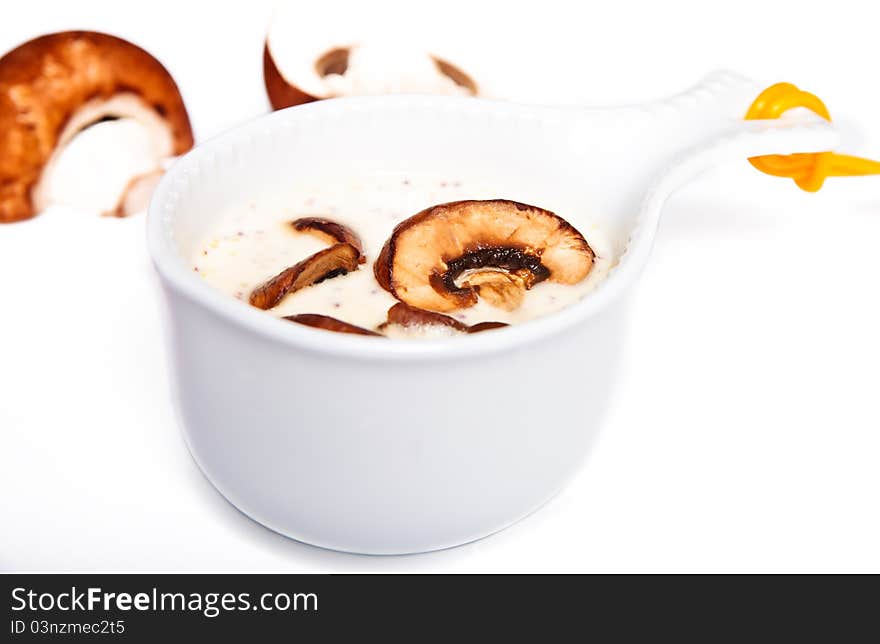 Mushrooms sauce in a white gravy boat