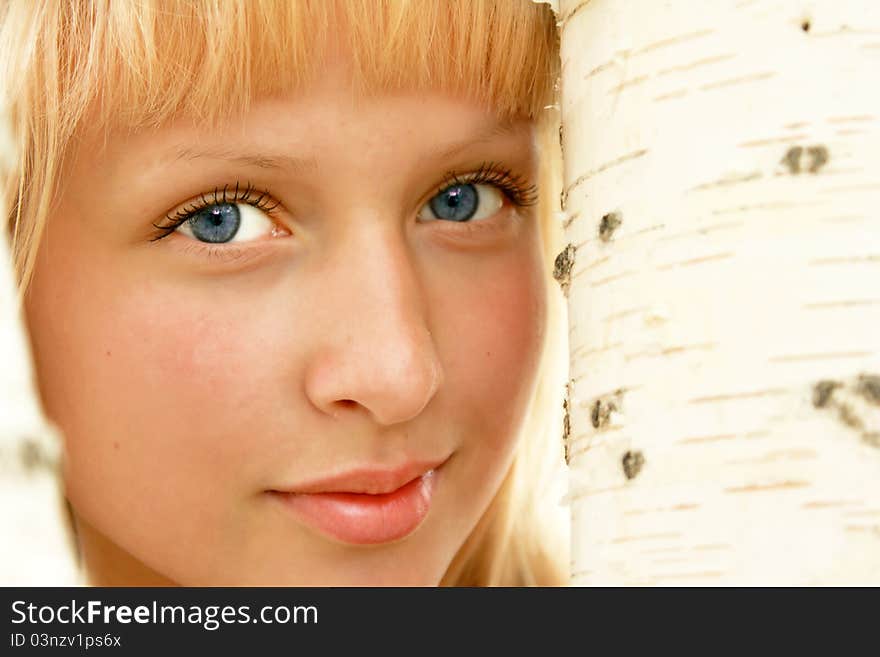 A young smiling girl with the birch. A young smiling girl with the birch