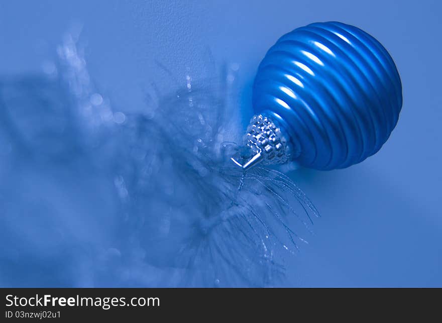 Blue Christmas ornament against blue background. Blue Christmas ornament against blue background