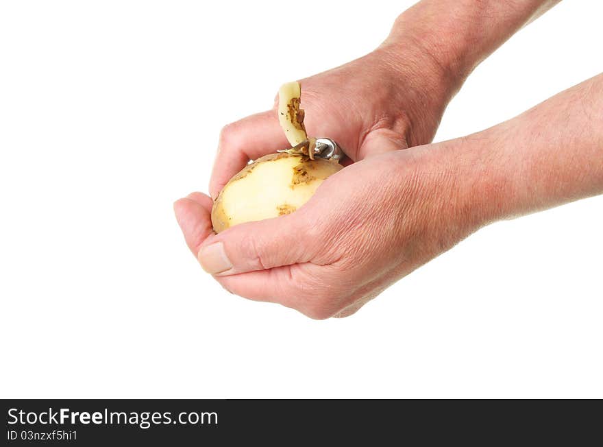 Hands Peeling A Potato