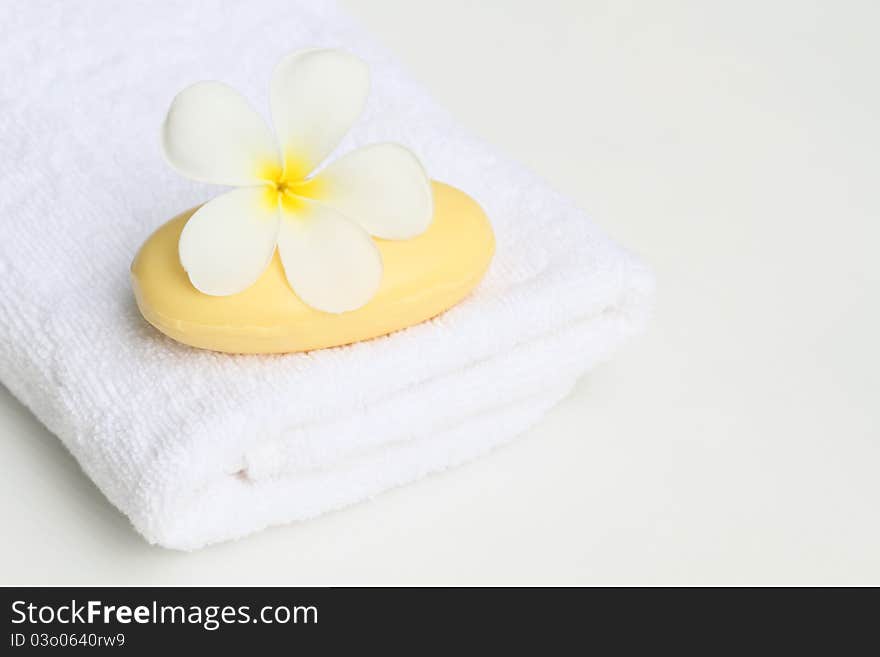 White towel,plumeria flower and soap. White towel,plumeria flower and soap