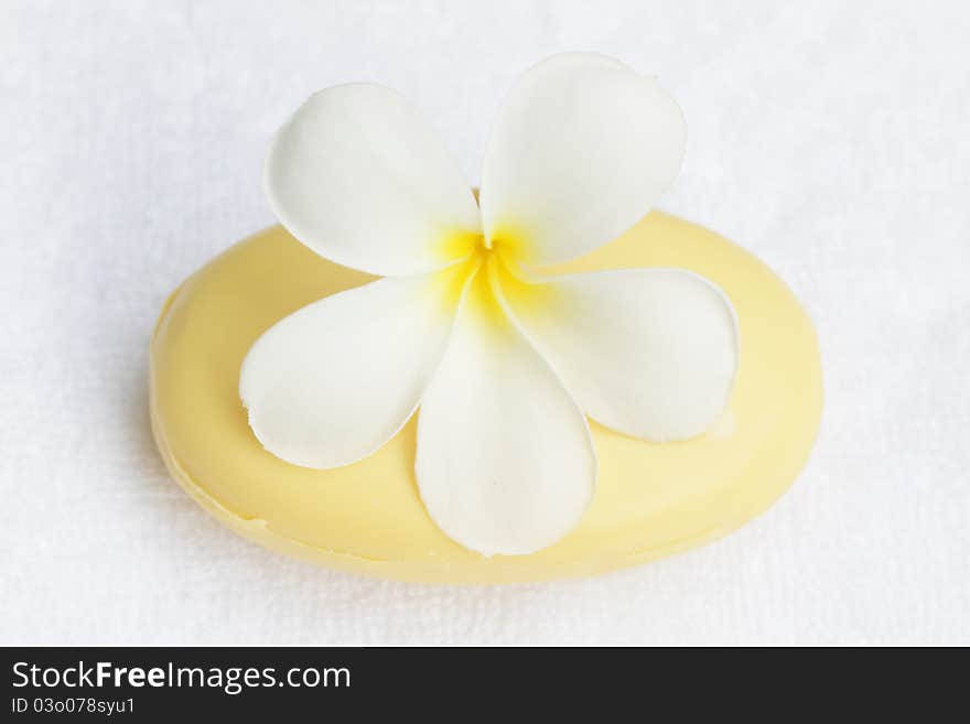 White towel,plumeria flower and soap. White towel,plumeria flower and soap