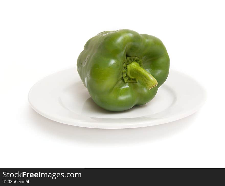 Green paprika on white plate