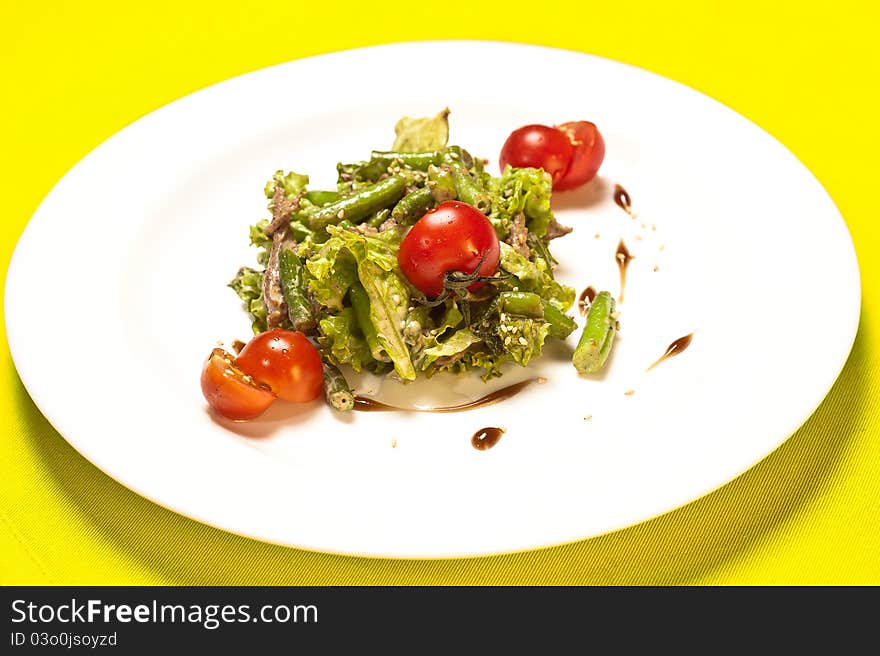 Closeup of plate of asparagus and tomato salad