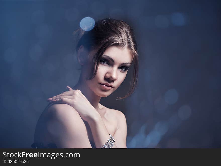 Fashion portrait of the young brunette woman with perfect makeup. Beauty portrait studio shot. Fashion portrait of the young brunette woman with perfect makeup. Beauty portrait studio shot