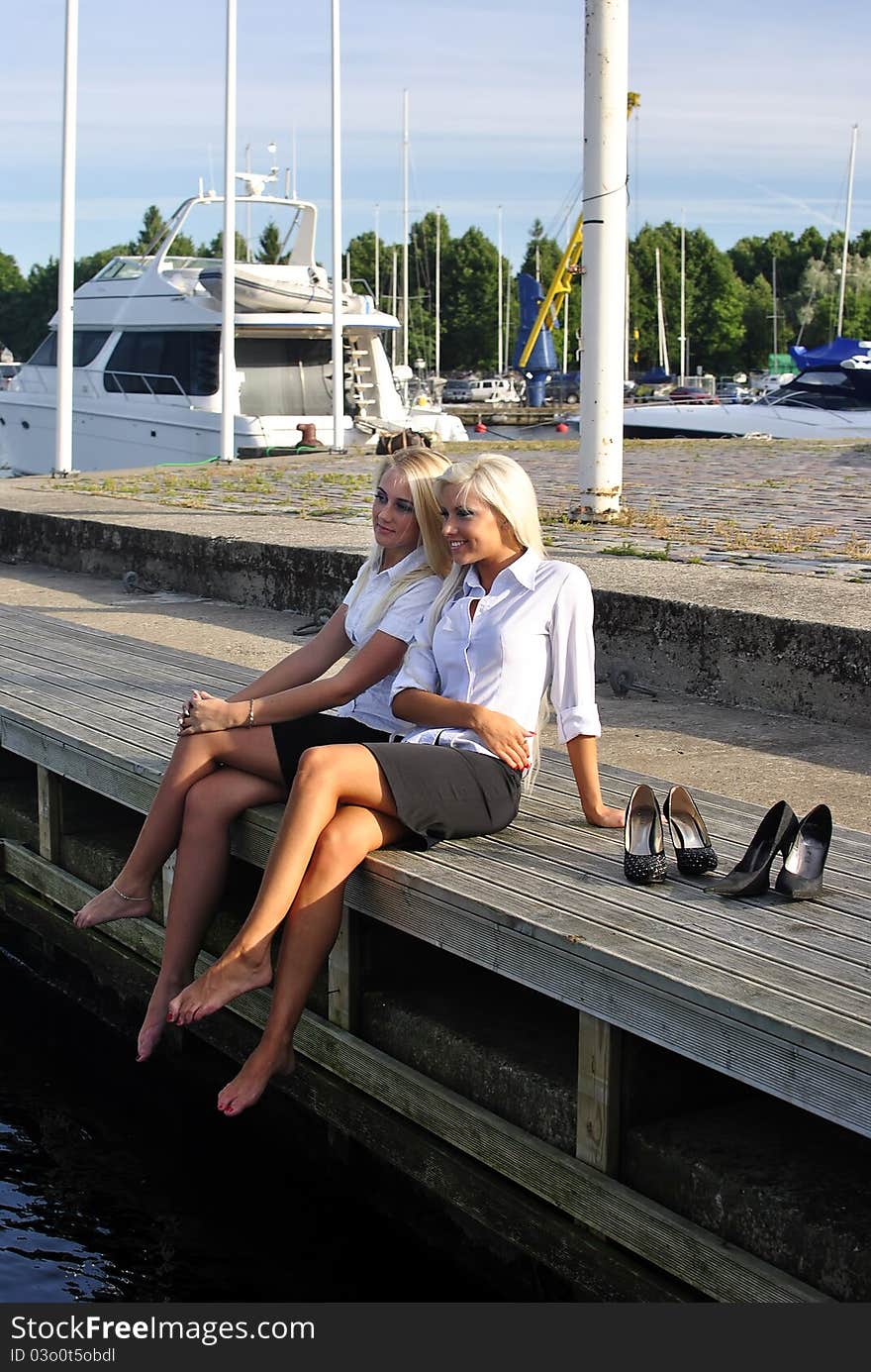 Two girls resting on the pier