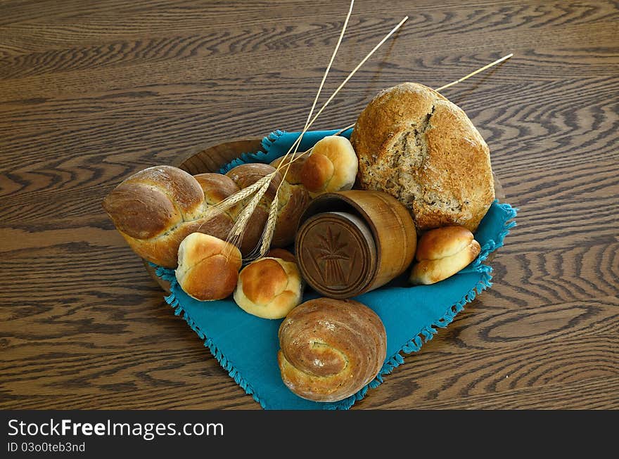 Wooden Bowl with variety of Whole Wheat Breads and vintage wheat shock stamped wooden butter mold. Wooden Bowl with variety of Whole Wheat Breads and vintage wheat shock stamped wooden butter mold