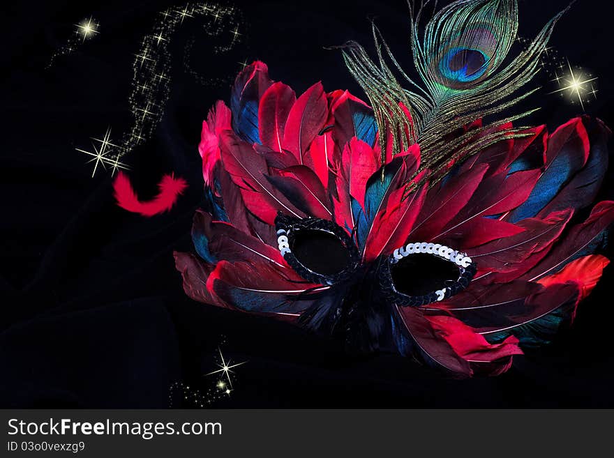 Beautiful carnival mask on black fabric