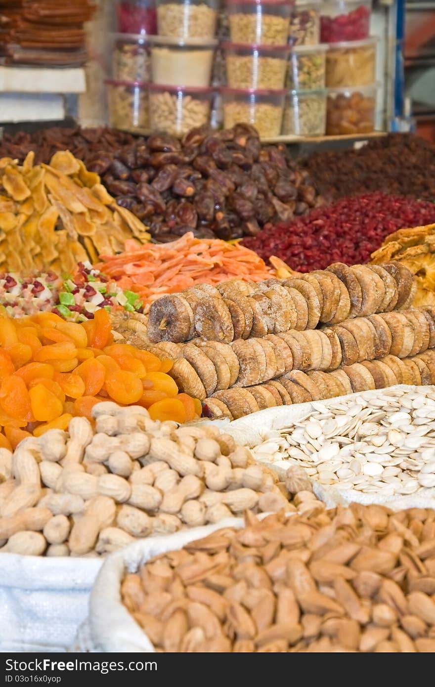 Colorful healthy dried fruits and nuts in the market, focus on figs. Colorful healthy dried fruits and nuts in the market, focus on figs