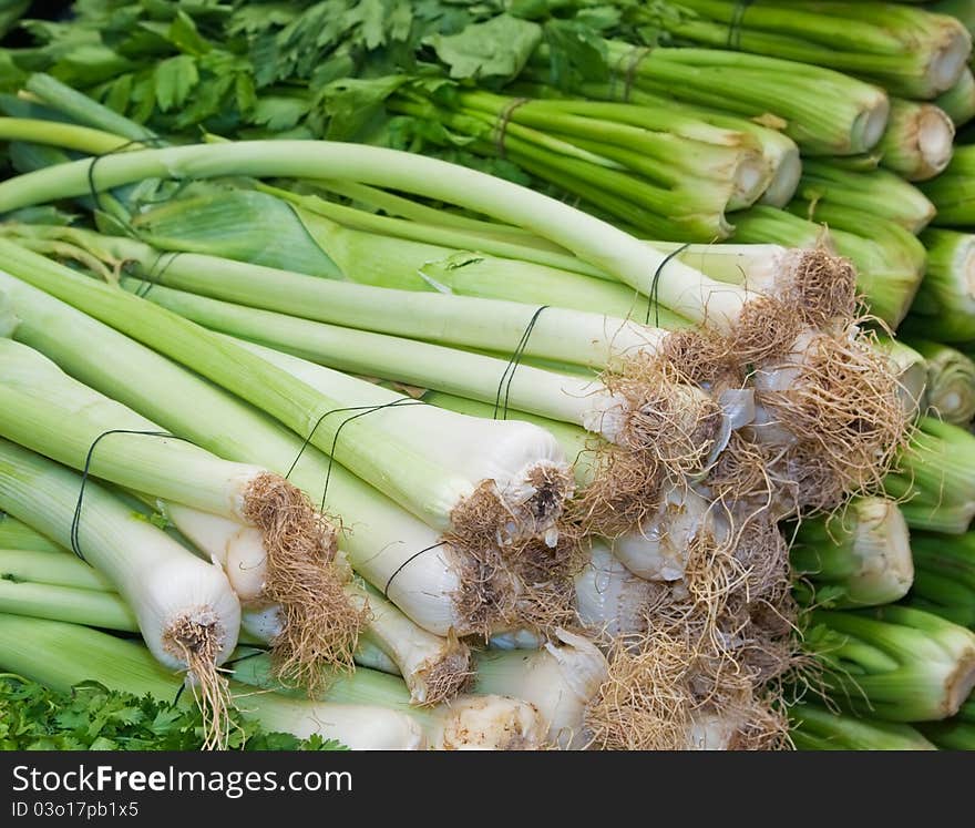 A bunches of fresh healthy leek and celery at the market