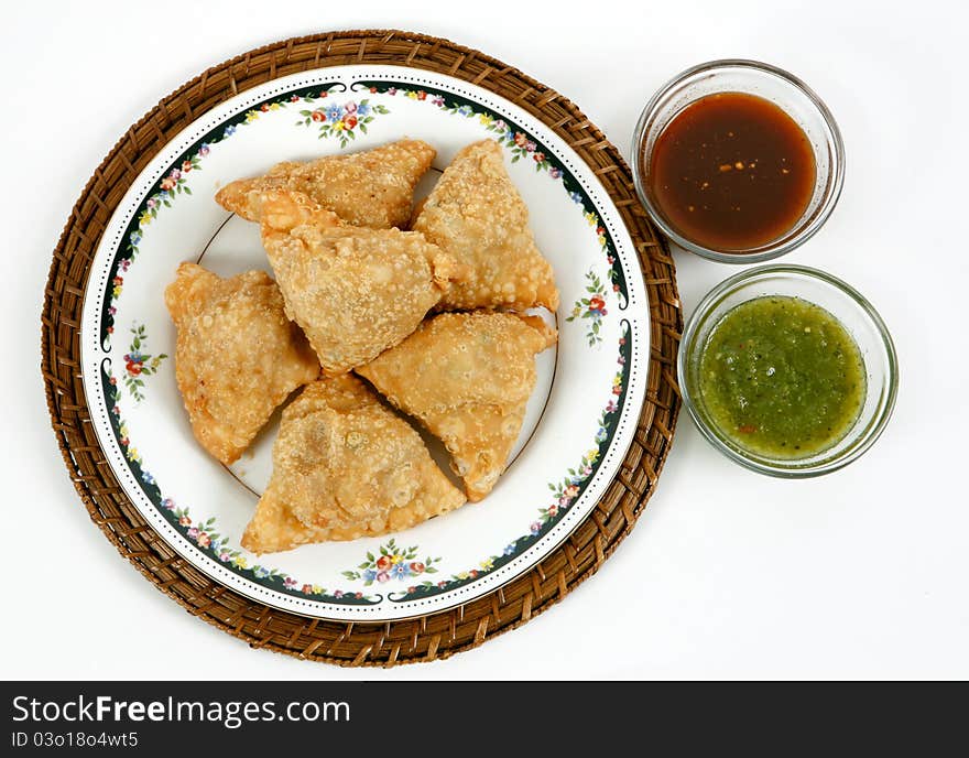 Fresh and hot samosas with sauce in plate