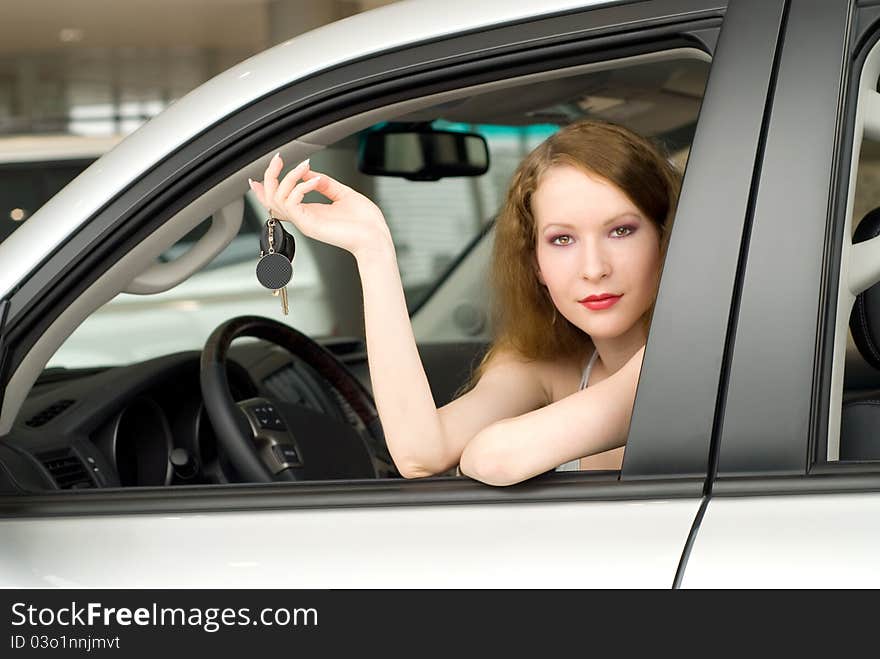 Beautiful young woman at the car with key. Beautiful young woman at the car with key