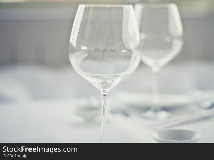 Close-up glass in front of another glass in restaurant