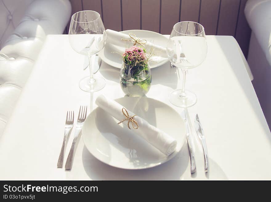 Served table with glasses for two persons in cafe