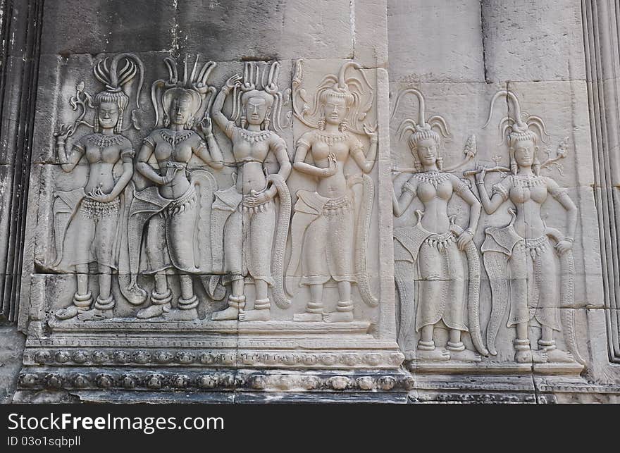 Apsaras engraved in the wall performing eternal dance.