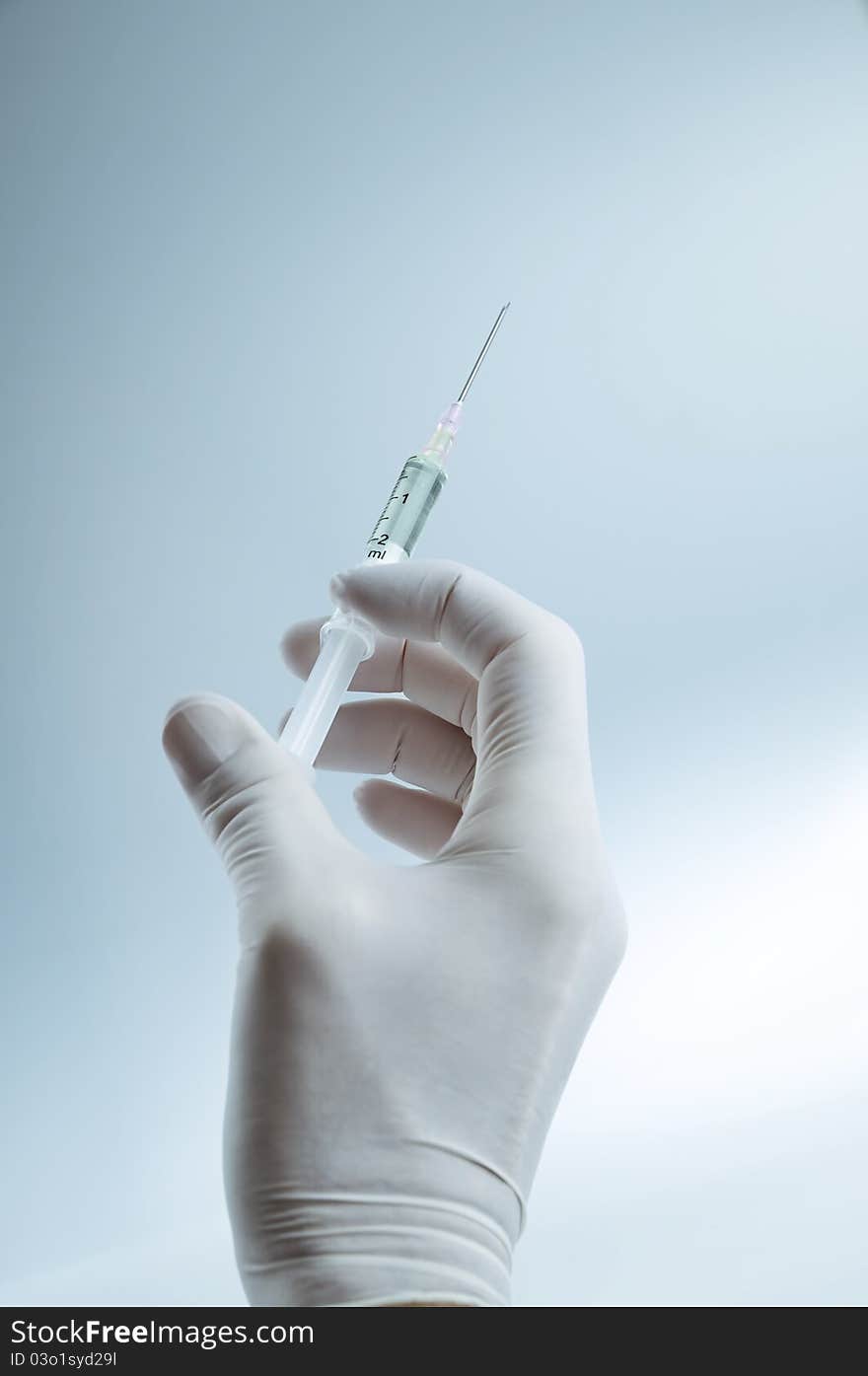 Doctor holding a syringe for injection. Doctor holding a syringe for injection