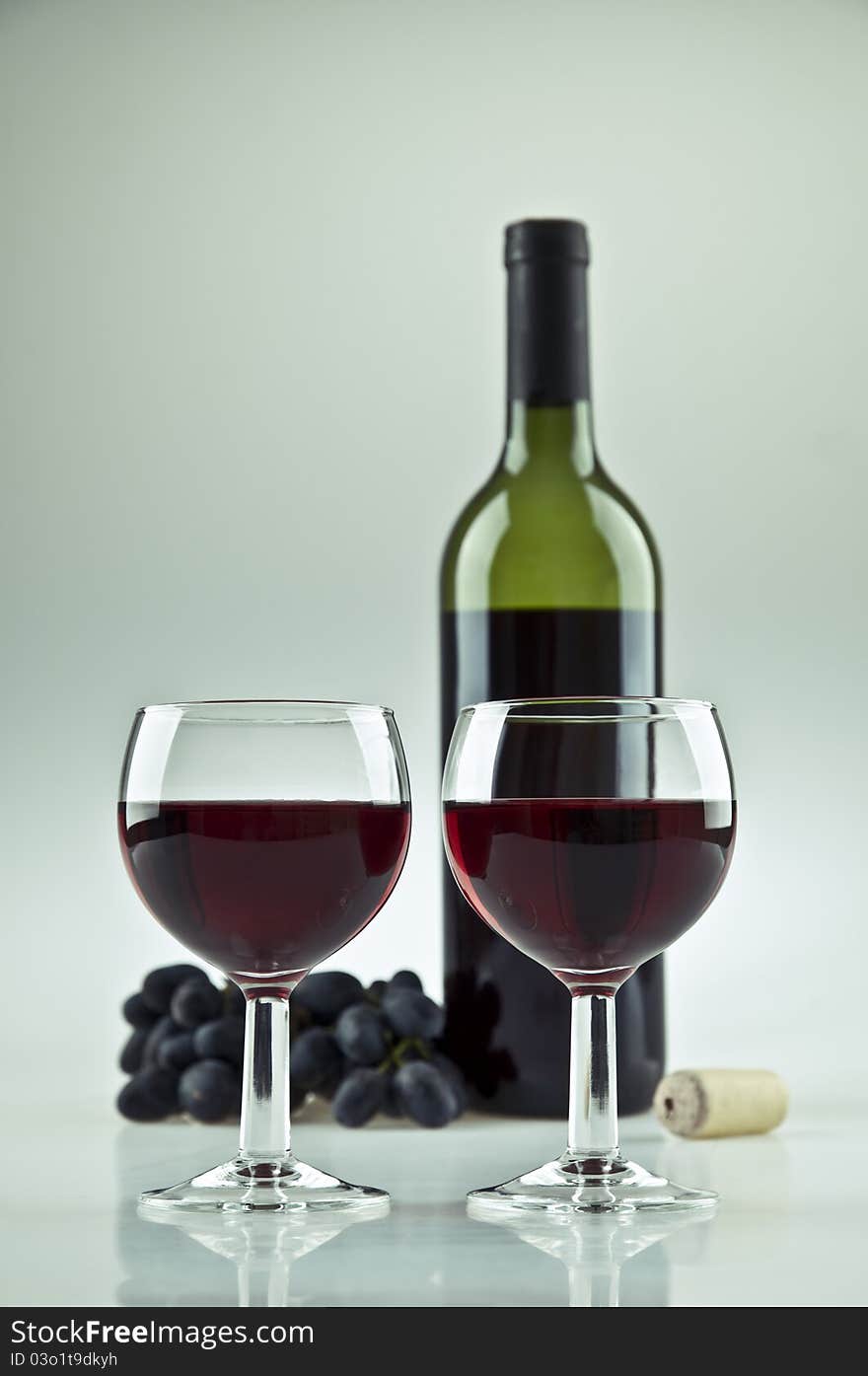 Two glasses and a bottle of red wine. Two glasses and a bottle of red wine