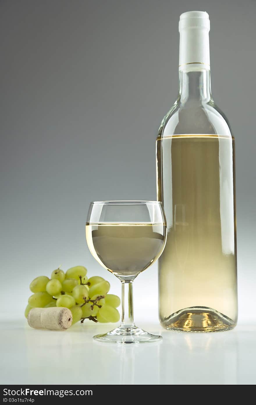 White wine, a bottle, a glass and some grapes. White wine, a bottle, a glass and some grapes