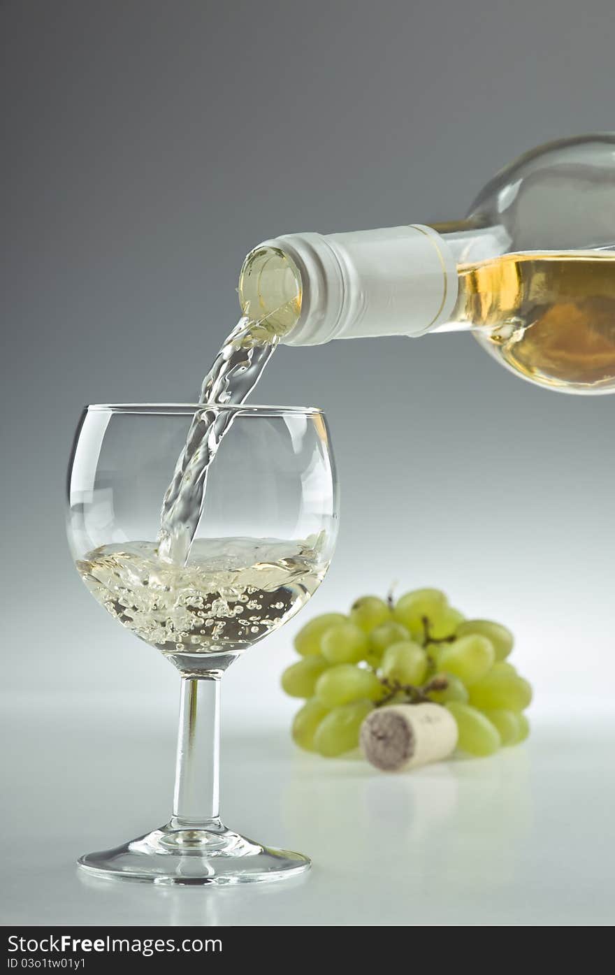 Pouring a glass of white wine. Pouring a glass of white wine