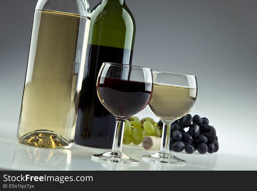 Red and white wine bottles and glasses