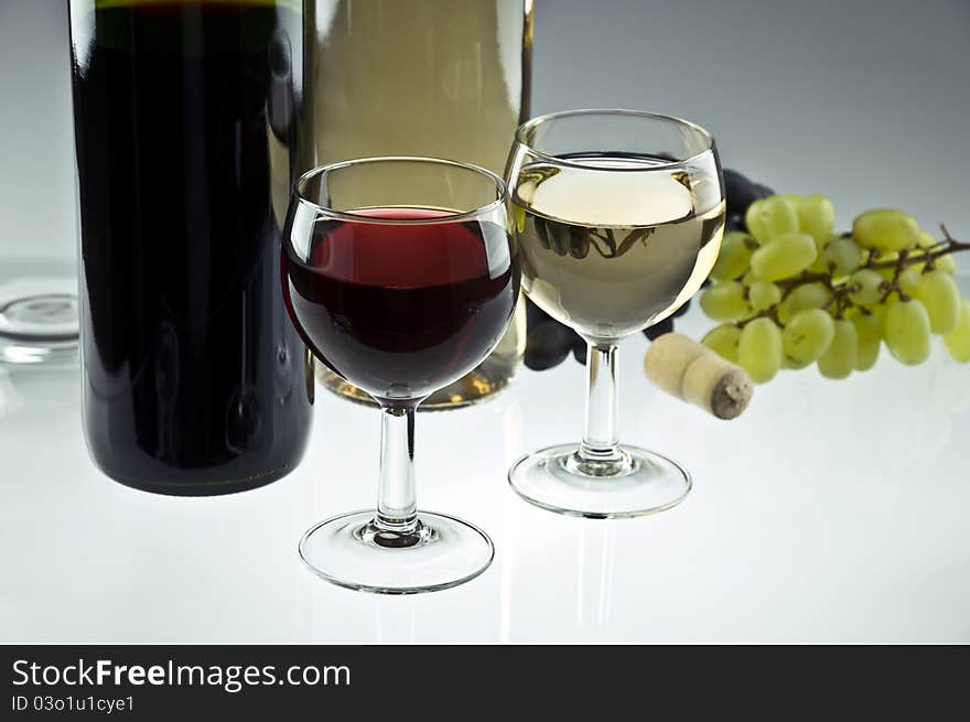 Red and white wine bottles and glasses