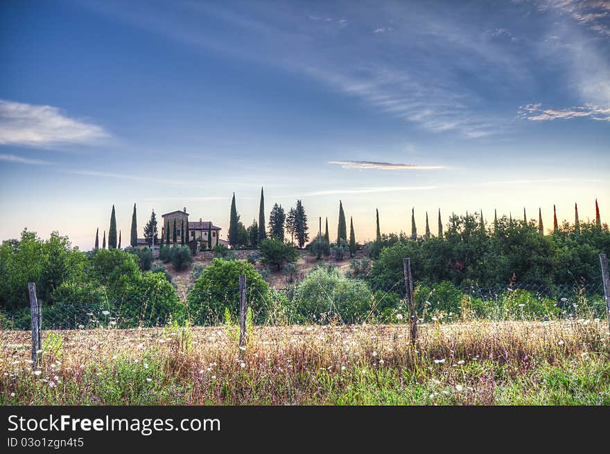 Sunrise in Tuscant over a Farm surrounded by Cypresses. Sunrise in Tuscant over a Farm surrounded by Cypresses