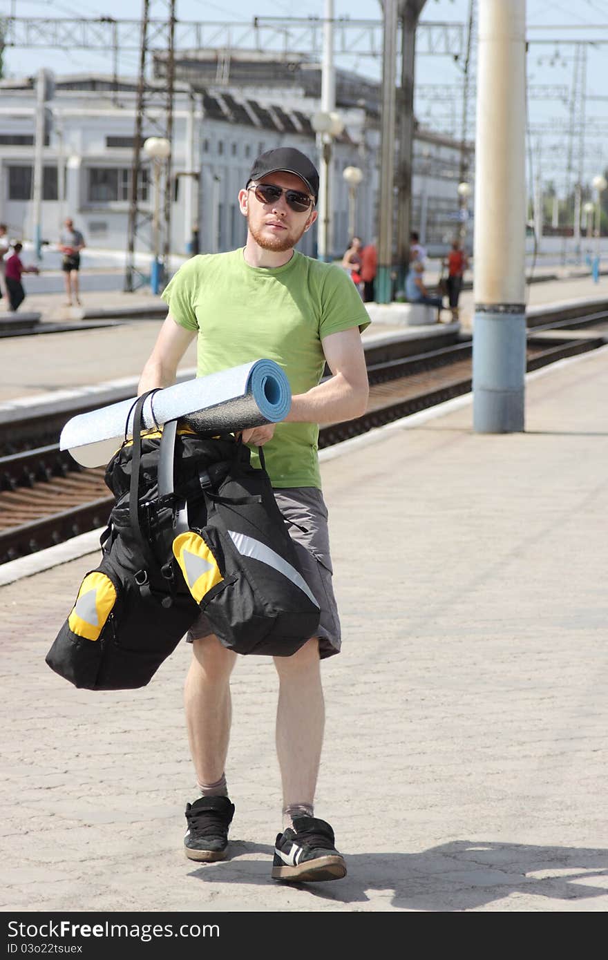 Bicycle tourist with backpack walking