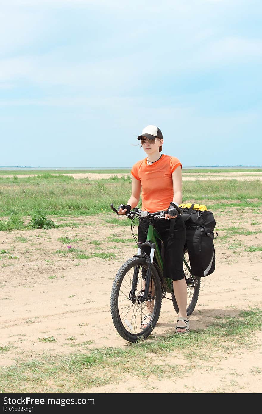 Bicycle tourist girl standing on road