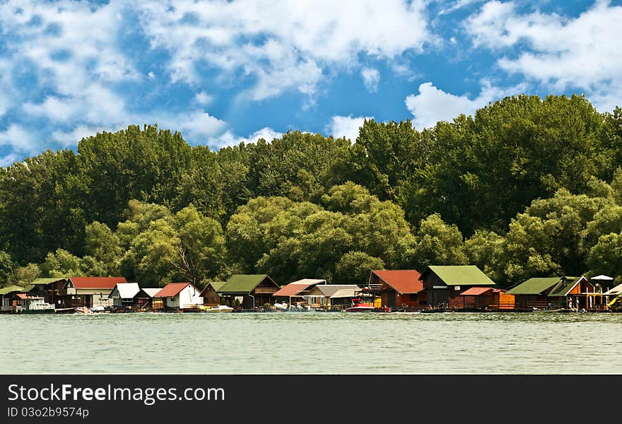 Scene of many boathouses on river