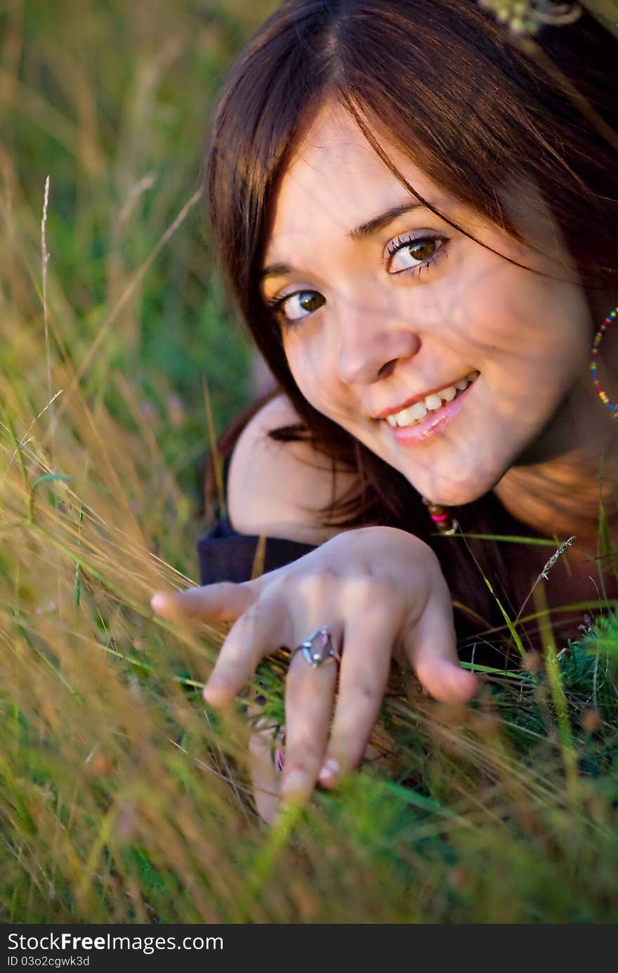 Smiling beautiful woman laying on grass