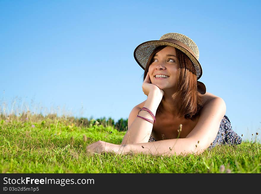 Smiling beautiful woman laying on grass