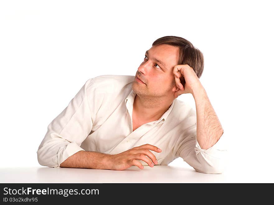 Cute adult man sitting at table on white. Cute adult man sitting at table on white