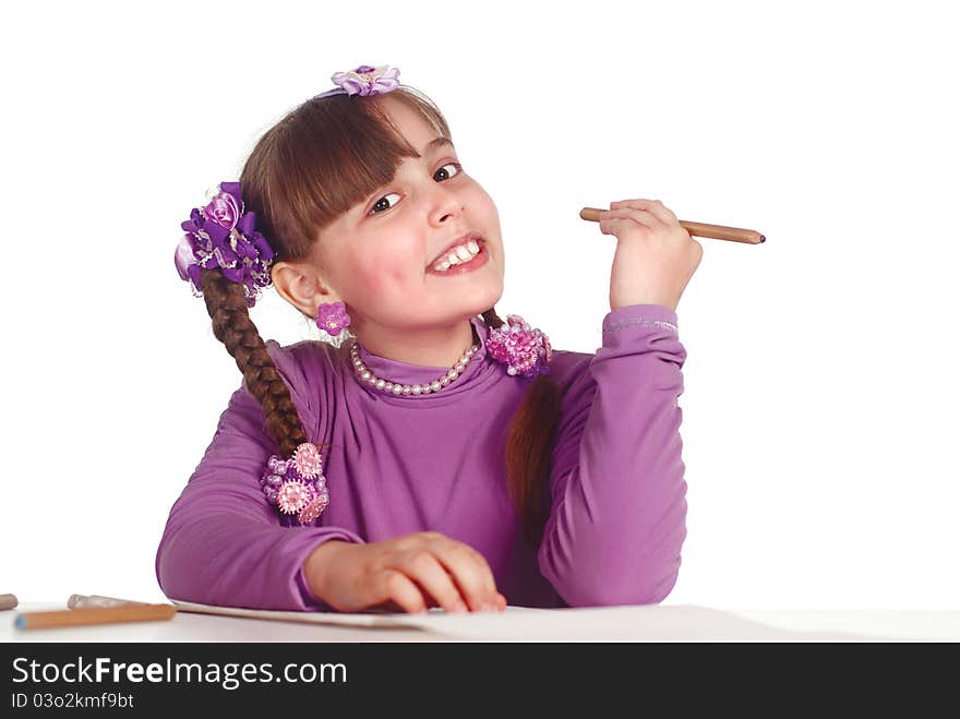 Portrait of a young girl drawing at table