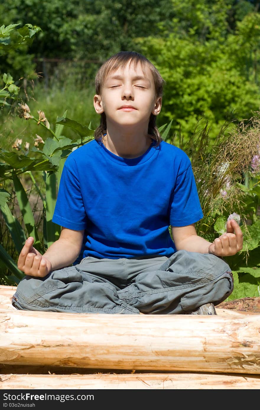 Cute young boy meditates at the nature. Cute young boy meditates at the nature