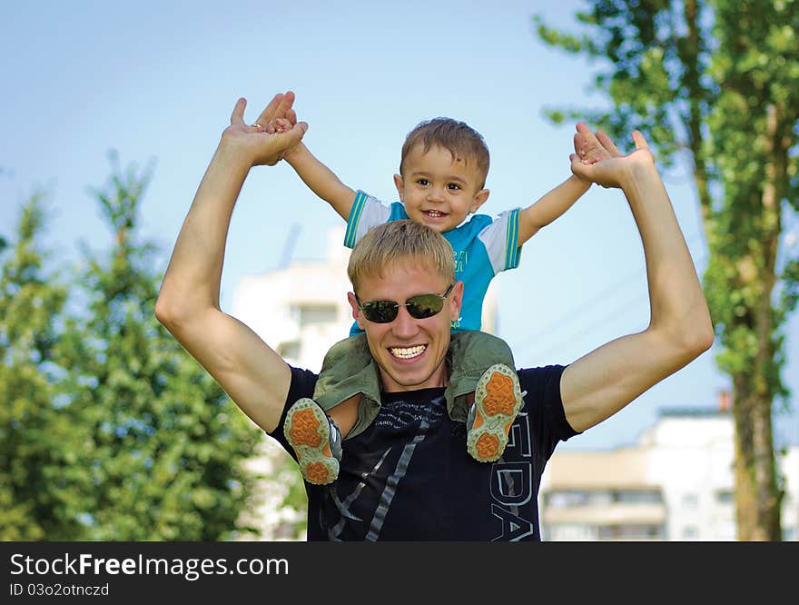 Dad with his son walking in a park. Dad with his son walking in a park