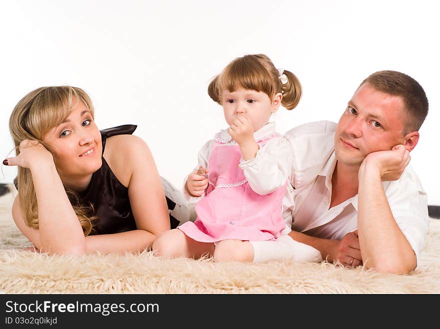 Nice family of a three playing on a carpet. Nice family of a three playing on a carpet