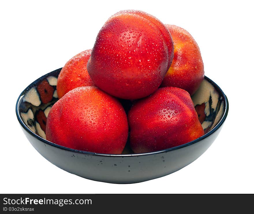 A bowl full of nectarines. The nectarines are fresh, wet, vibrant and juicy. A bowl full of nectarines. The nectarines are fresh, wet, vibrant and juicy.