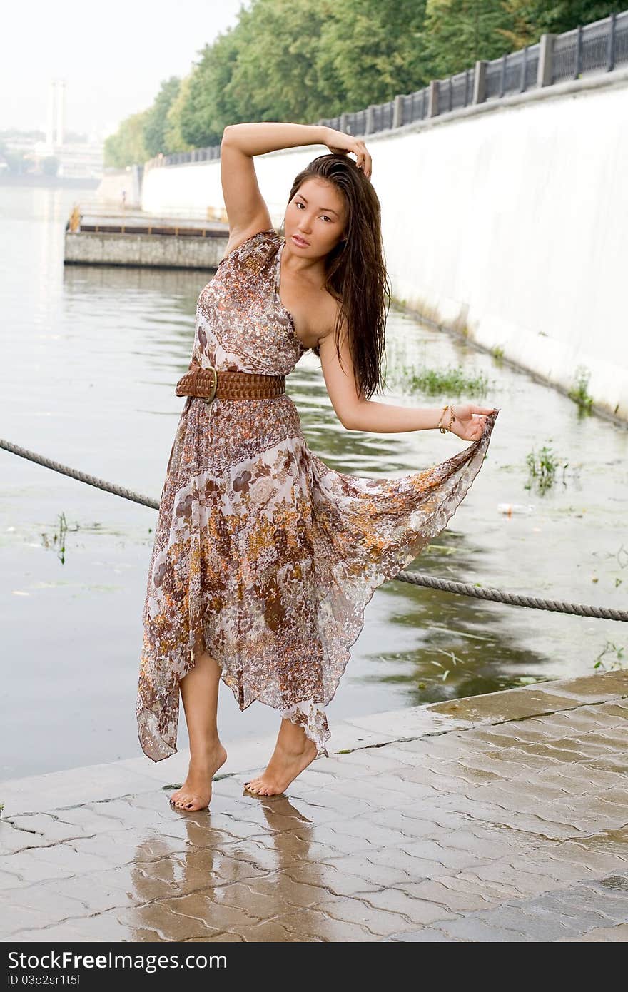 Beautiful girl walking near river