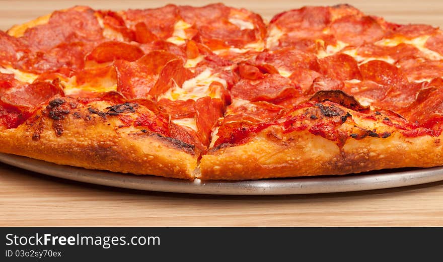 A very tempting image of a delicious pepperoni pizza. This image is a closeup to add uniqueness to the photograph.