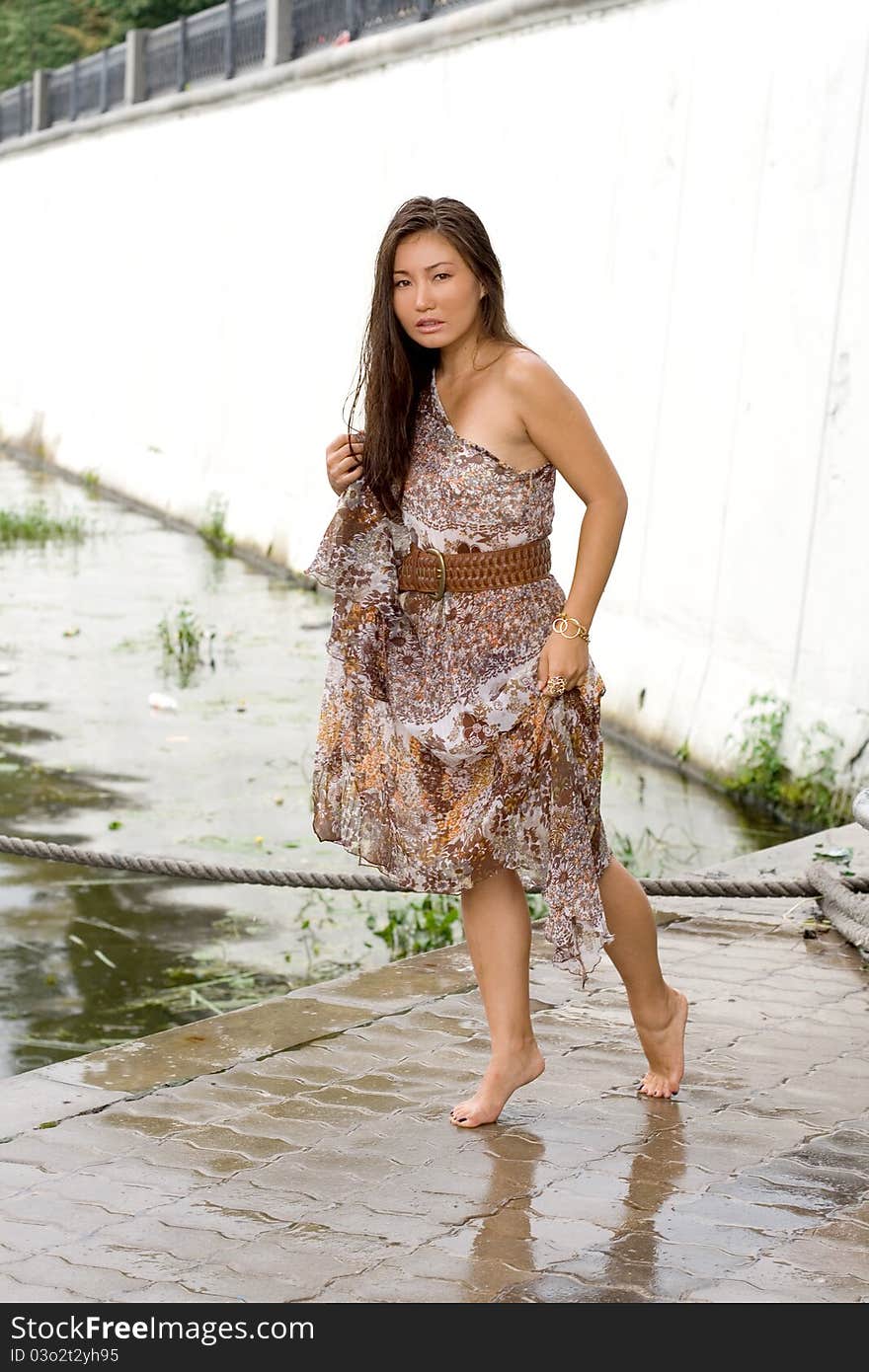 Beautiful girl walking near river