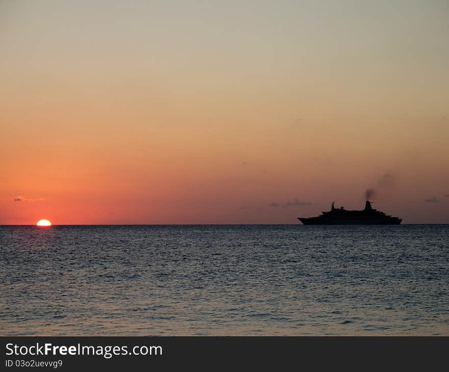 Silhouette of a cruiseship sailing into the setting sun. Silhouette of a cruiseship sailing into the setting sun