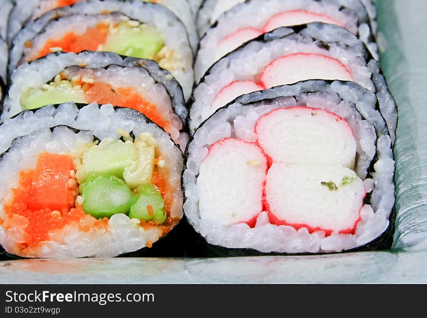 Sushi roll into a circle are arranged on the plate beautifully