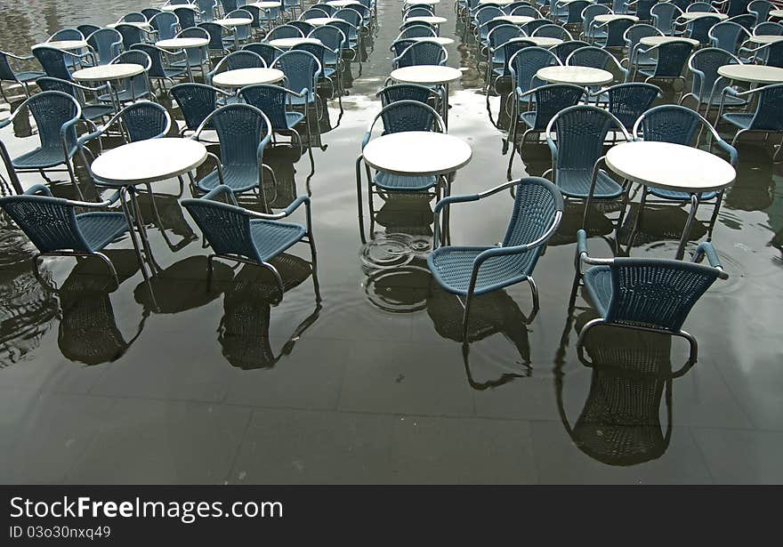 Chairs and tables submerged in water