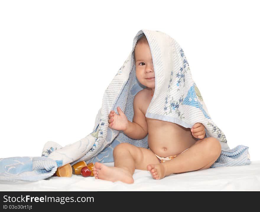 Beautiful baby looking out from under towel