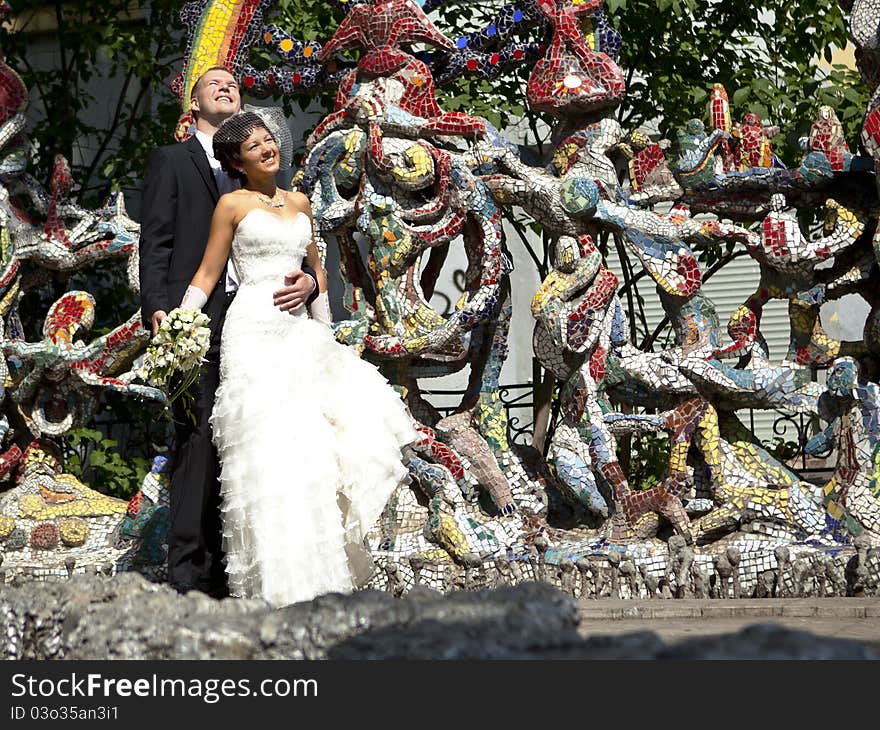 Bride and groom standing at the colorful walls. Bride and groom standing at the colorful walls