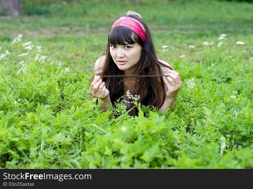 Pretty girl lying on grass in park