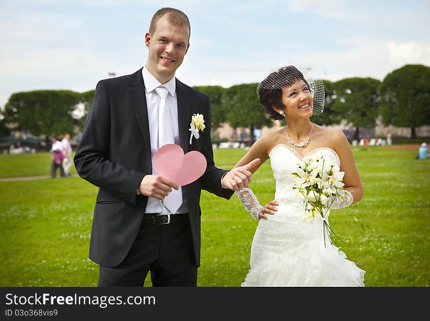 Bride and groom walking in park. Bride and groom walking in park