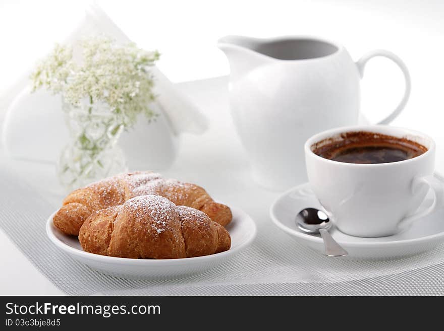 Breakfast with coffee and croissant