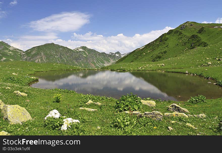 Mountain lake with reflections in summer season